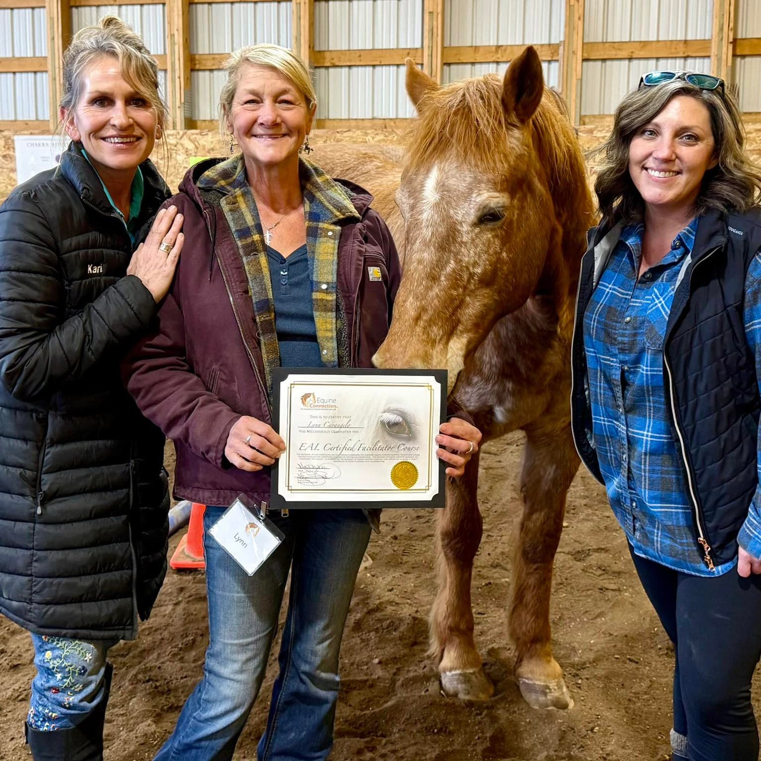 Women celebrating together with a horse